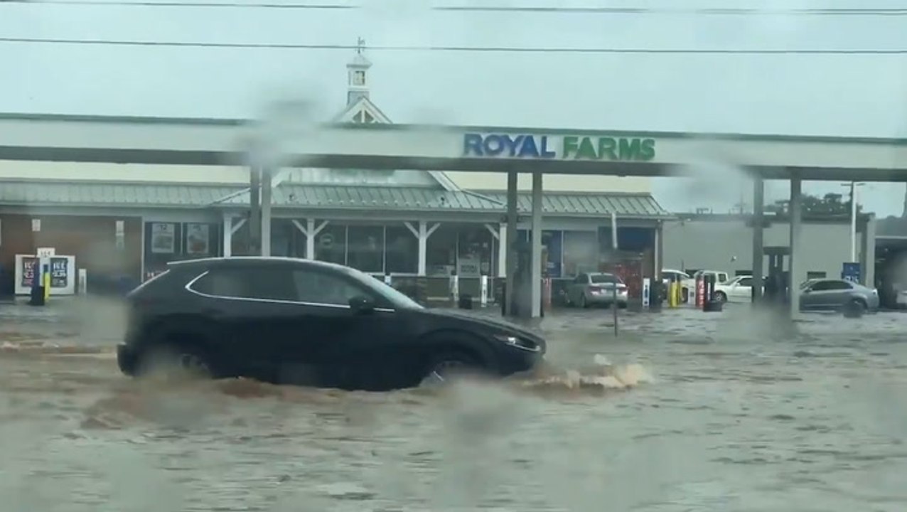 Motorists plow through deep floodwaters