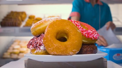 70-year-old Brooklyn shop hangs doughnuts on a glazing wall to coat each ring evenly