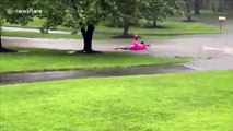 Man floats down flooded street on inflatable flamingo in New Jersey