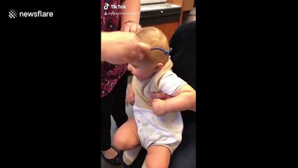 Baby reacts to seeing himself for the first time using glasses
