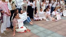 A group of young women sing and hold flowers during protests in Belarus