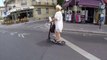 Pet parrot rides on scooter handlebars in the streets of Paris
