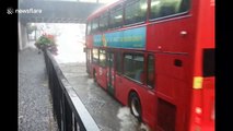 Cars drive straight through flooded bridge in Greater London