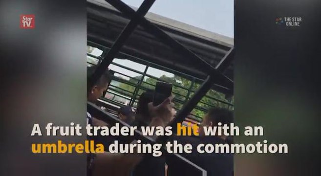 Fruit trader hit with umbrella during scuffle with enforcement officers