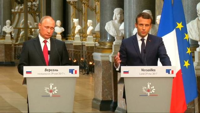 Macron, alongside Putin, blasts Russian media meddling