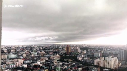 Dark grey clouds loom over Bangkok before rainstorm batters city
