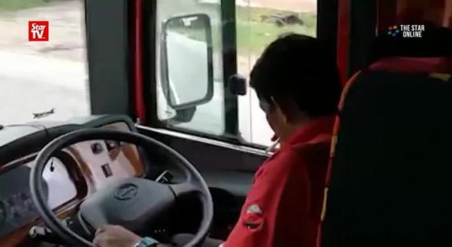 Bus driver caught red handed using phone while driving