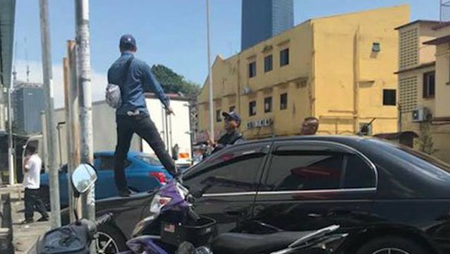 Unhappy with DBKL's car clamping, man protests on car