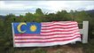 Youths drape giant Jalur Gemilang over iconic 'Ipoh' sign