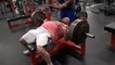 Man Slaps Friend's Belly to Motivate Him as He Struggles While Lifting Weights