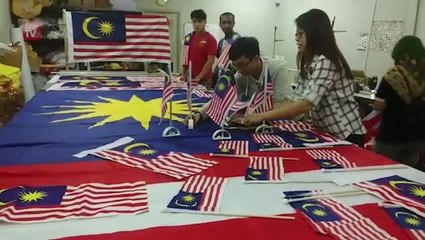 Flag making family gets busy nearing Merdeka
