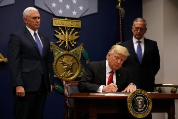 Trump signs order limiting refugees