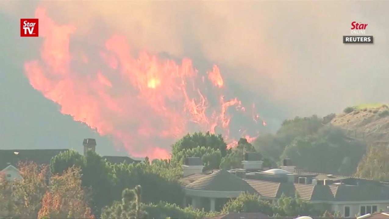 California wildfires rage on, threatening LA ne...