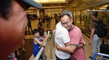 Malaysian and Singaporean journalists arrive home