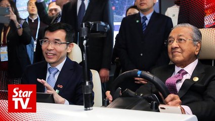 Dr Mahathir gets first-hand AI experience with self-driving car in Beijing