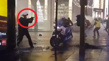 French policeman pulls gun on protesters