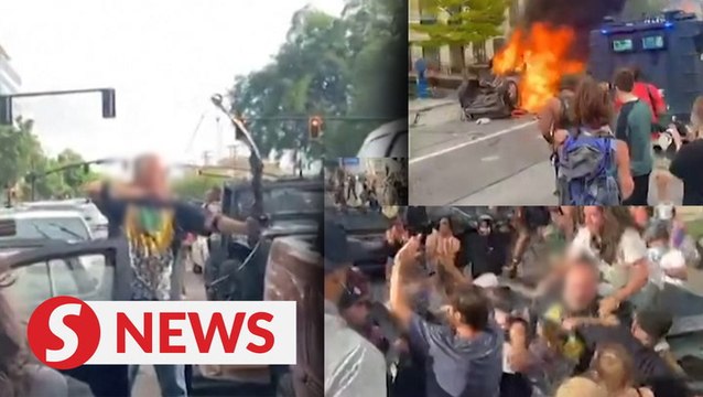 Man swarmed by protesters after pointing bow and arrow at crowd in US