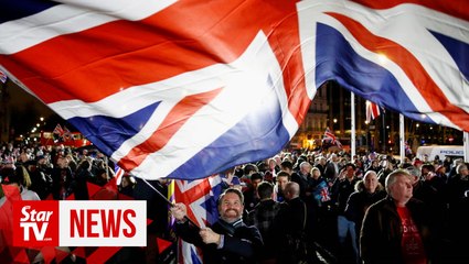 Download Video: Brexit Day revelers with balloons and flags waving in Parliament Square