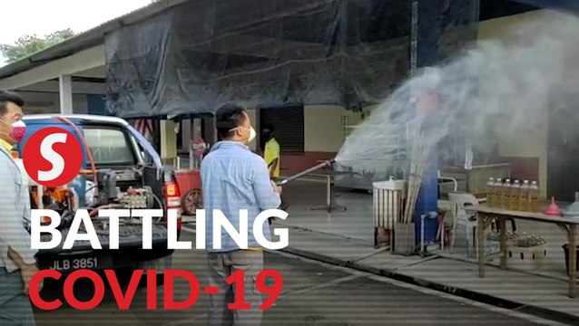 Brothers disinfecting public areas with DIY mix in Johor