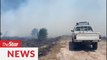 Firemen battling to stop wildfires in Miri