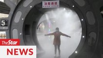 Covid-19: Disinfectant tunnel in China sprays workers