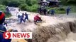 Video shows flash flood dragging motorcyclist off the road in Nepal