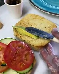 PLANT BASED “Vegucated Order” sandwich!  Loaded with TOFUrkey. Vegan “bacon” strips. Vegan coconut “bacon” jam. Avocado. Basil aioli, lemon vin, tomato, greens.