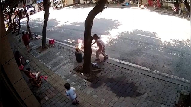 Woman drags gas cylinder on road after accidentally igniting it in China