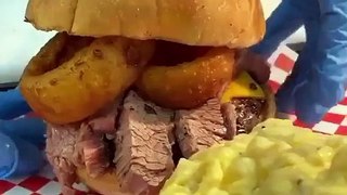 BBQ BRISKET BURGER  Burger topped with cheddar, brisket, onion rings, toasted brioche.
