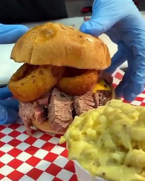 BBQ BRISKET BURGER Burger topped with cheddar, brisket, onion rings, toasted brioche.