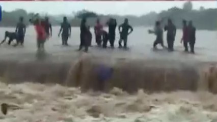 Boys perform dangerous stunt in flood water
