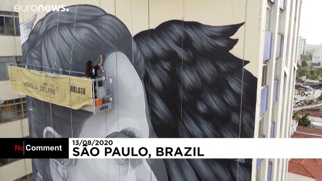 Graffiti artists paint giant murals on tower blocks in Sao Paulo
