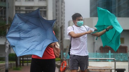 Hong Kong cleans up as typhoon Higos moves away and weather warnings lowered