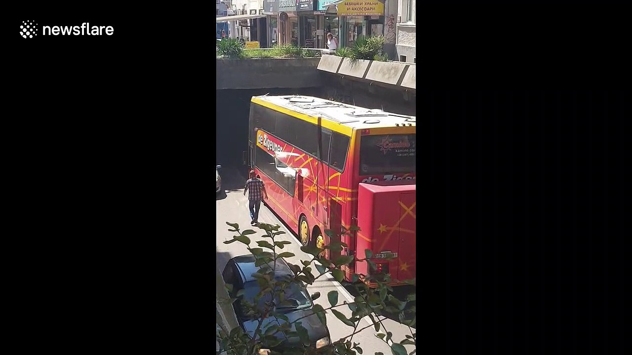 Double-decker coach carrying students smashes into underpass in Bulgaria and gets stuck