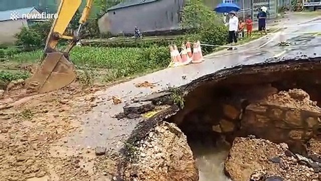 Flooding in Vietnam triggers landslides which leave roads damaged