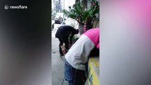 Filipino deliveryman rescues kitten from drain