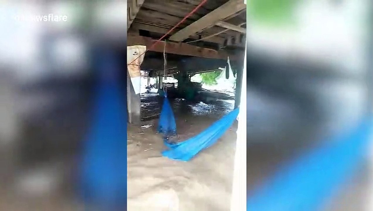Homes partially submerged by floodwater as heavy rain cause flash floods in northern Thailand