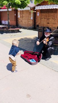 Little Boy Dances to Violin