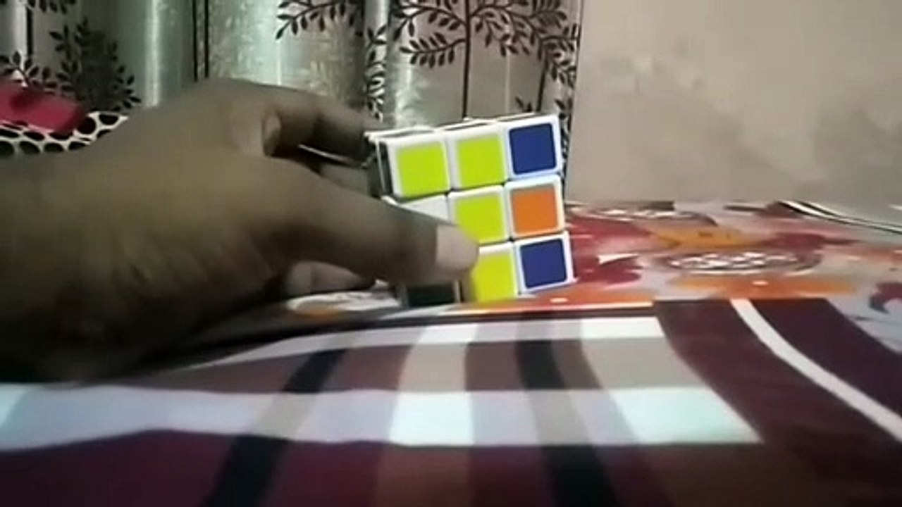 Solved rubix cube with left hand