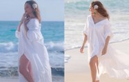 إطلالة أنغام بفستان أبيض جريء على البحر تثير حفيظة محبيها