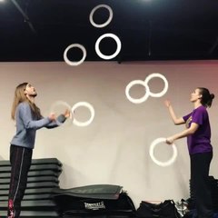 Duo Shows Off Color Changing Effect While Juggling Multiple Hoops Together