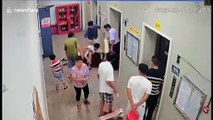 Chinese residents get trapped in lift after drunk man violently kicks it