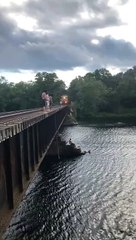Jumping Off a Bridge Close to a Train as it Approaches