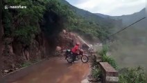 Chinese motorcyclist calmly watches massive landslide  in front of him