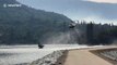 Helicopter picks up water at Bass Lake to fight raging Creek Fire in California