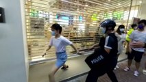 Hong Kong police officer tackles and pins 12-year-old girl to ground during anti-government rally