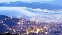 Mesmerising footage as clouds fall from the mountains covering Barcelona in fog before drifting out to the Mediterranean at sunrise