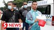 Jamal Yunos attempts to give towels worn in 2016 water protest to Selangor MB