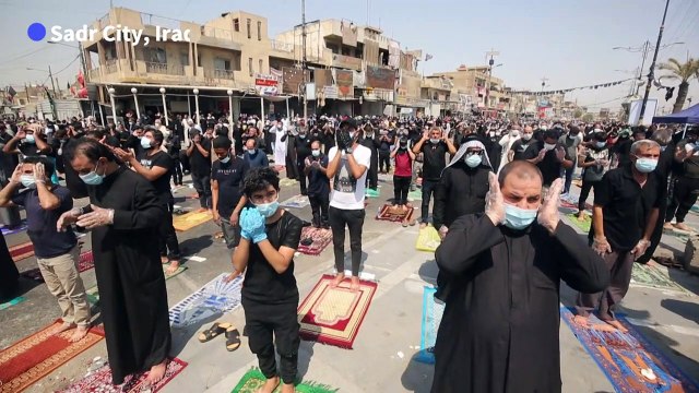 Iraqi Shiite Muslims take part in Friday prayers in Sadr City despite virus