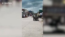 Landspout tornado stretches down from storm clouds in the Philippines